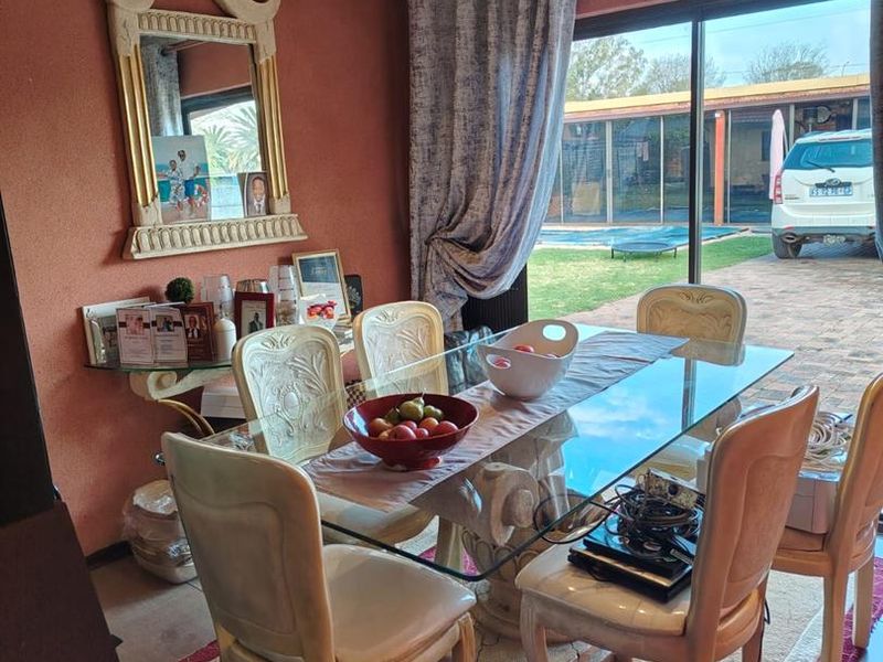 Dining room featuring a sliding glass door providing access to the outdoor patio and pool area.
