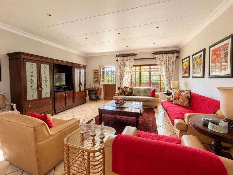 Spacious living room featuring tiled flooring, recessed lighting, and crown molding, with direct access to the exterior through a secure door.