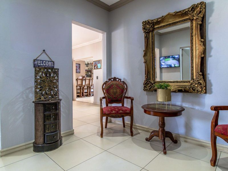 A welcoming entrance hall featuring neutral tiled flooring and recessed lighting, providing a clear transition into the main living areas of the home.