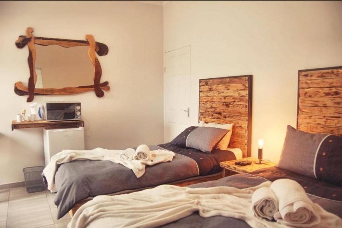 A bedroom featuring tiled flooring, a built-in door, and a wall-mounted shelf unit.