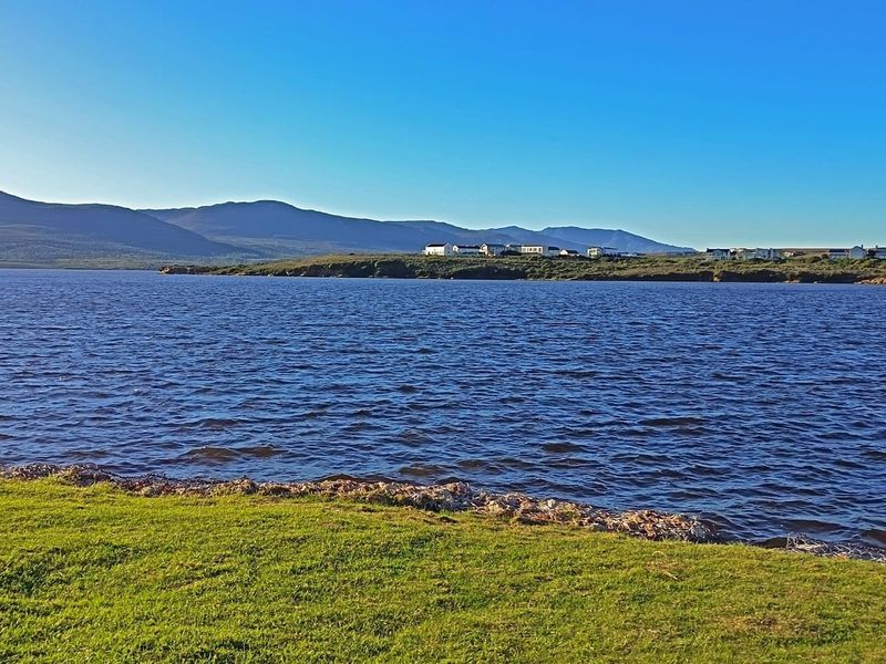 A scenic view of the waterfront landscape, showcasing the natural beauty and tranquil surroundings of the vacant residential land.
