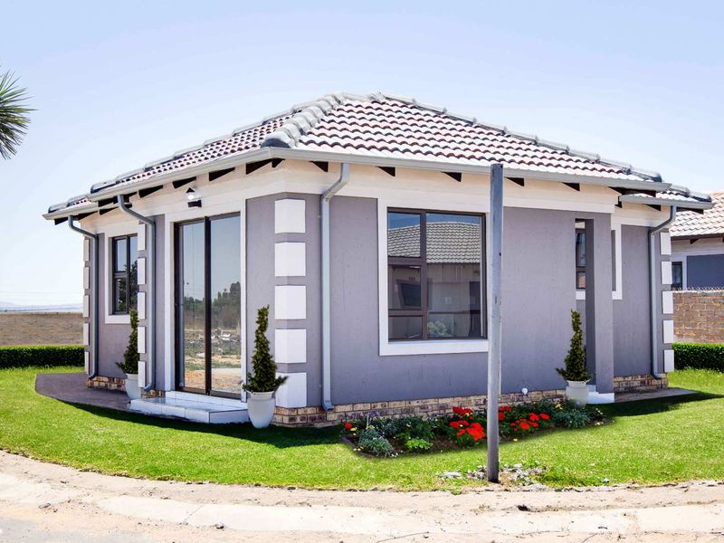 A well-maintained single-story residential home featuring a tiled roof, grey exterior walls with white corner detailing, and aluminium-framed windows and sliding doors.