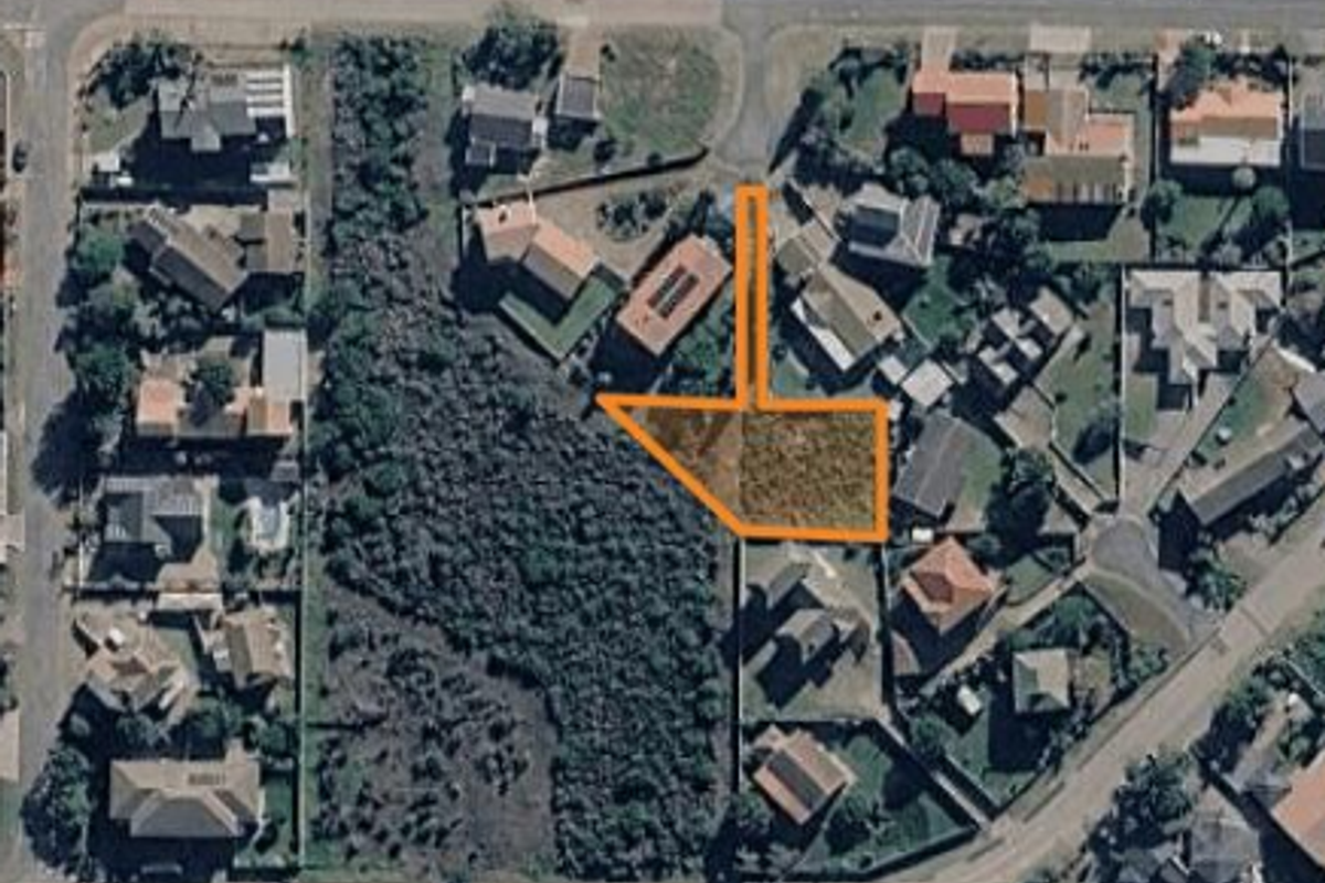Aerial view of a vacant residential plot highlighting the property boundaries within an established suburban neighborhood.