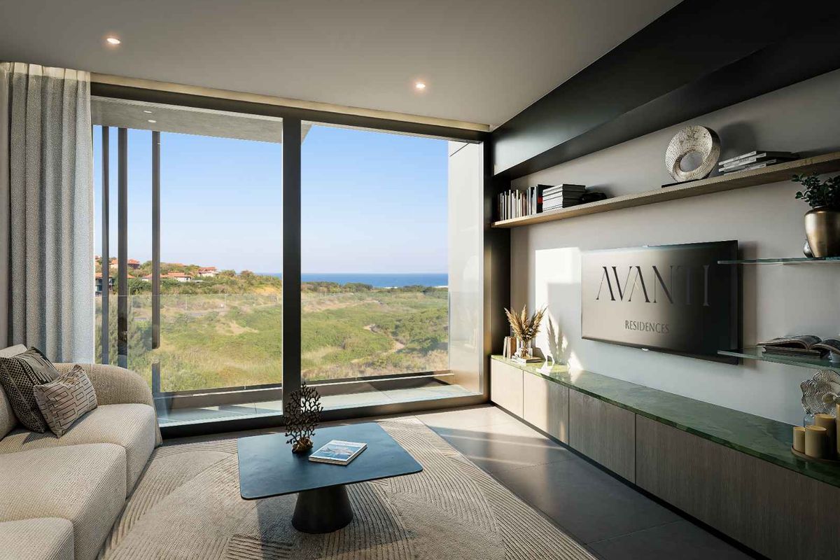 Modern living room featuring floor-to-ceiling sliding glass doors, custom built-in cabinetry with stone shelving, and expansive coastal views.