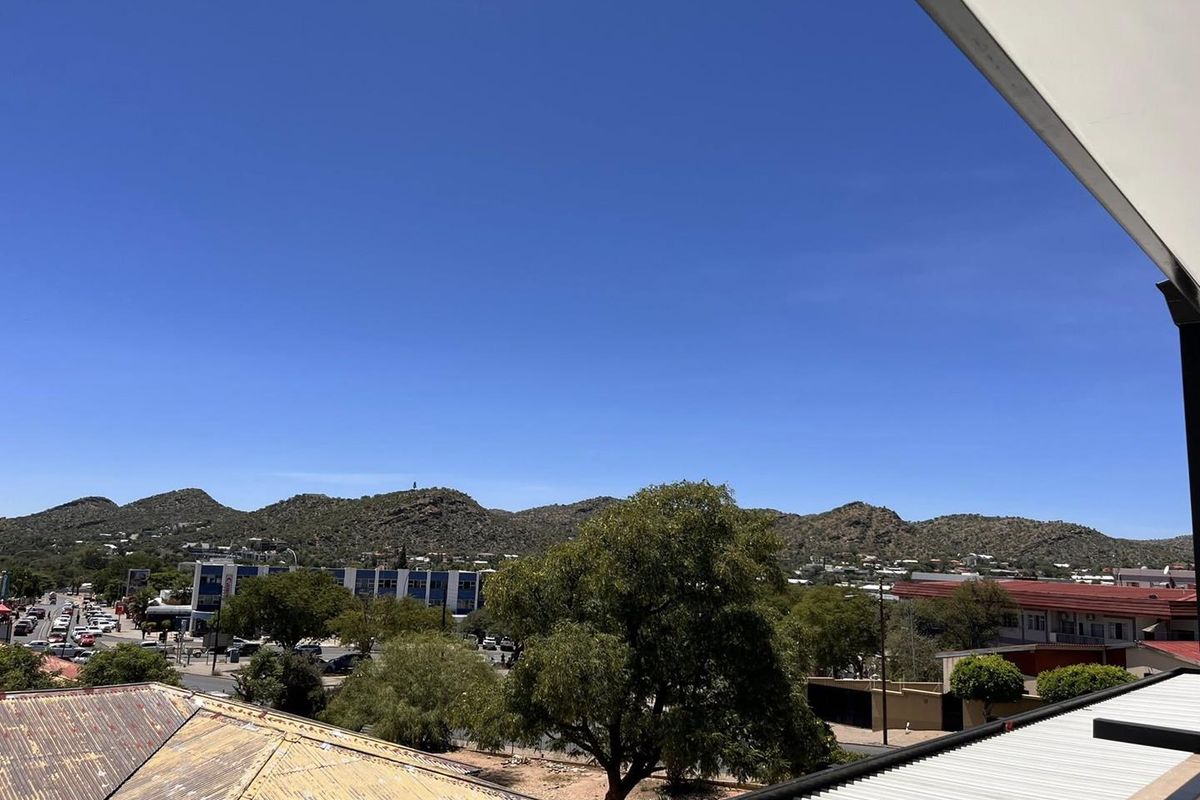 Elevated outdoor view overlooking the surrounding neighbourhood, local street infrastructure, and distant mountain range.