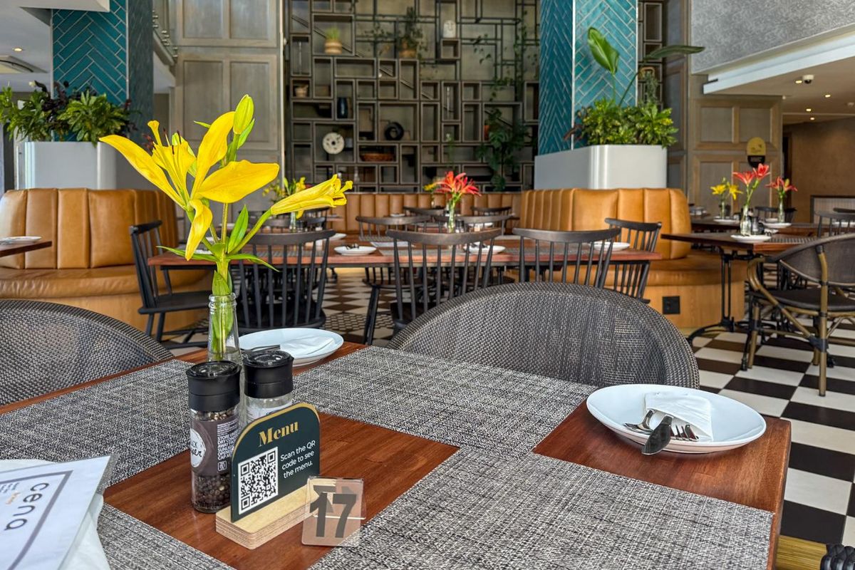 A well-appointed dining area featuring decorative wall tiling, built-in shelving, and classic checkered flooring, creating a sophisticated and inviting atmosphere.