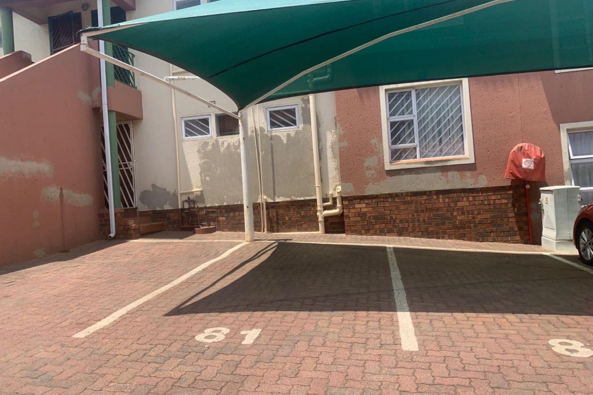 Dedicated parking bay with a shade cloth cover located at the rear of the apartment complex.