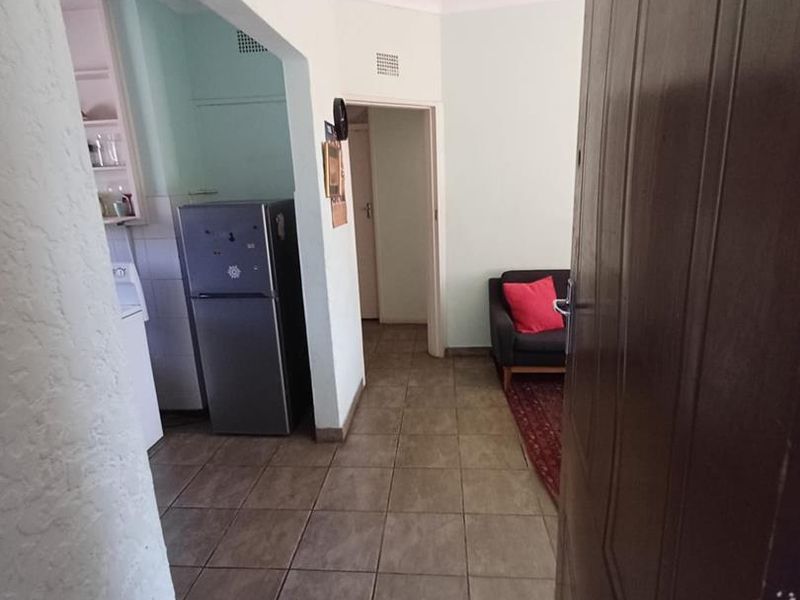 Entrance area featuring tiled flooring and an archway leading into the living space, providing a functional transition point within the apartment.