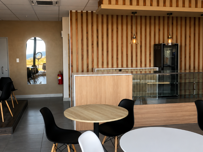 Modern open-plan retail space featuring timber slat wall accents, a built-in service counter with glass display, and recessed ceiling lighting.