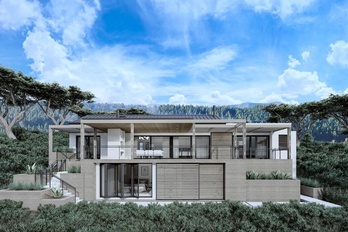 Modern architectural rear elevation featuring a spacious covered patio, bi-fold doors, and tiered landscaping set against a scenic mountain backdrop.