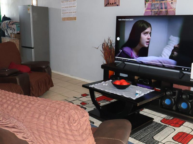 A living room area featuring tiled flooring, providing a functional space for relaxation and entertainment.