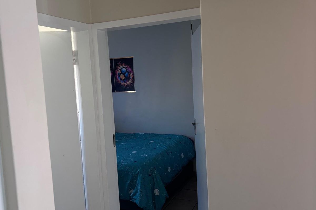 A view through a doorway into a bedroom space.