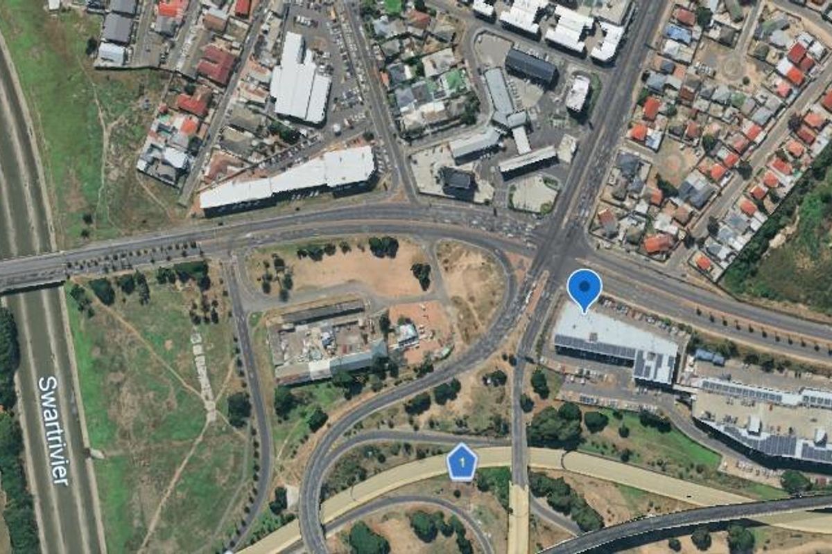 Aerial view of the commercial office property location, highlighting surrounding road infrastructure, highway access, and urban neighborhood context.