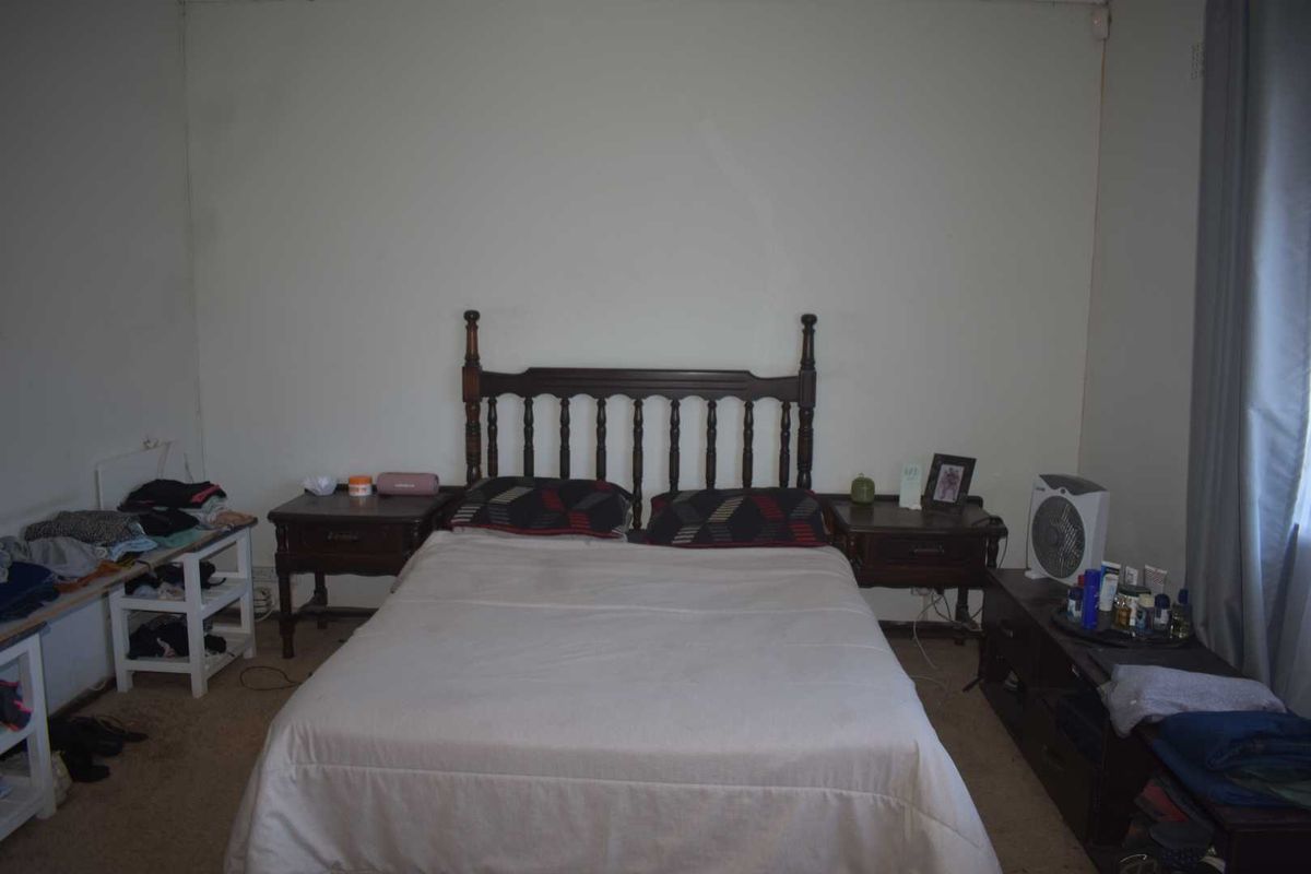 A bedroom featuring carpeted flooring and neutral wall finishes, providing a functional space for rest.