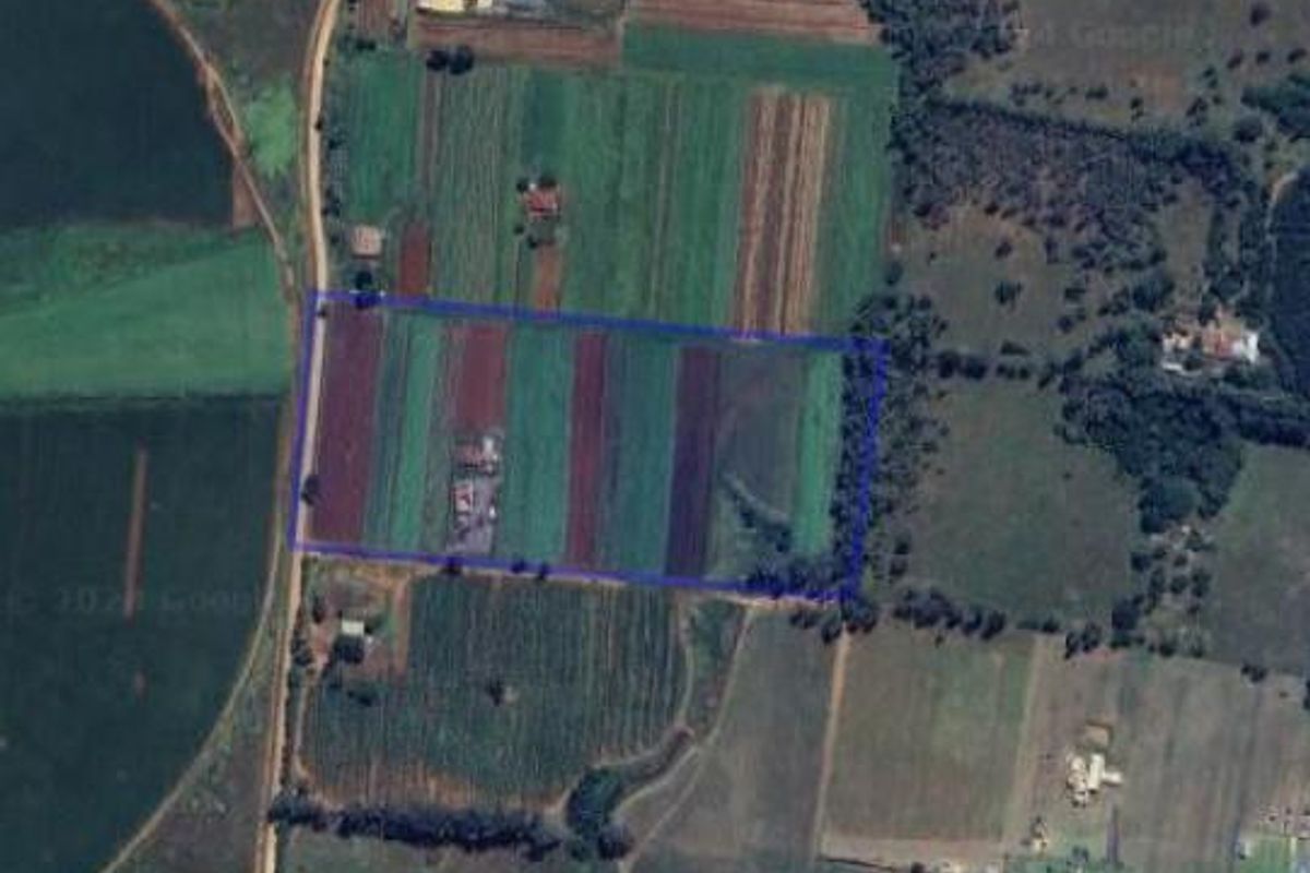 Aerial view of the farm property showing the land boundaries, cultivated fields, and surrounding rural landscape.