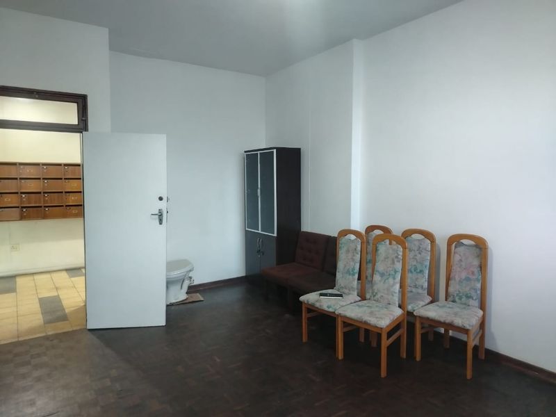 Entrance foyer area featuring parquet flooring and a bank of wall-mounted mailboxes, providing a functional transition space for the apartment.