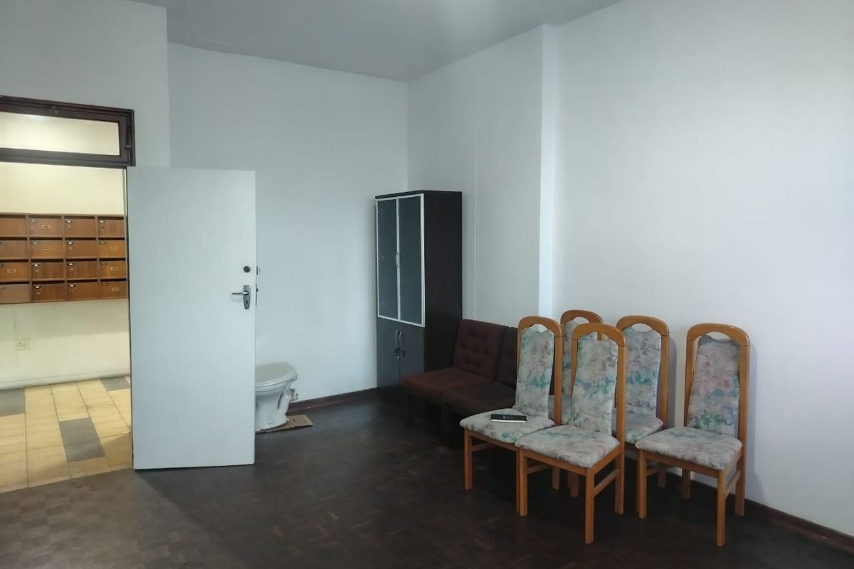 Entrance foyer area featuring parquet flooring and a bank of wall-mounted mailboxes, providing a functional transition space for the apartment.
