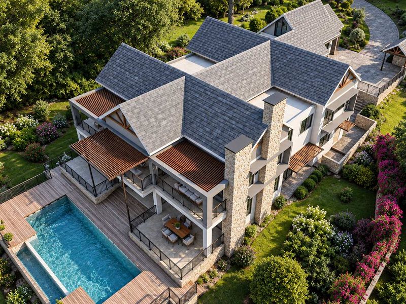 Aerial view of a luxury residence featuring a swimming pool, timber decking, stone accents, and extensive landscaped gardens.