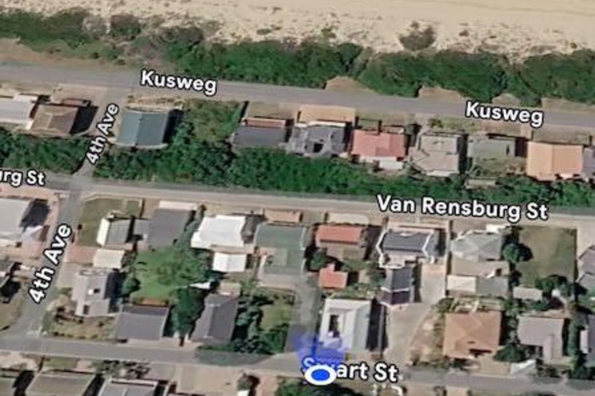 An aerial view of the residential neighborhood and coastal proximity, showing the street layout and surrounding properties.