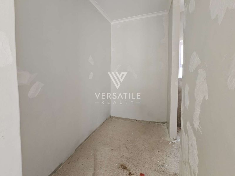 An unfinished bedroom space featuring bare concrete floors and walls requiring final plastering and painting, offering a blank canvas for renovation.