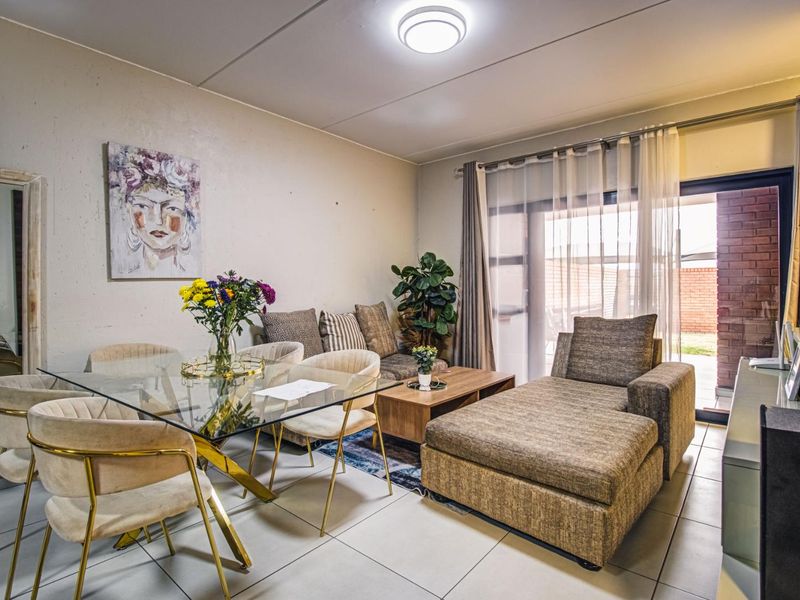 Open plan living and dining area featuring tiled flooring and a sliding glass door providing access to the outdoor space.