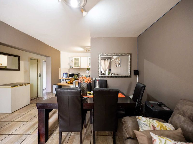 Open plan living and dining area featuring tiled flooring and direct access to the kitchen space.