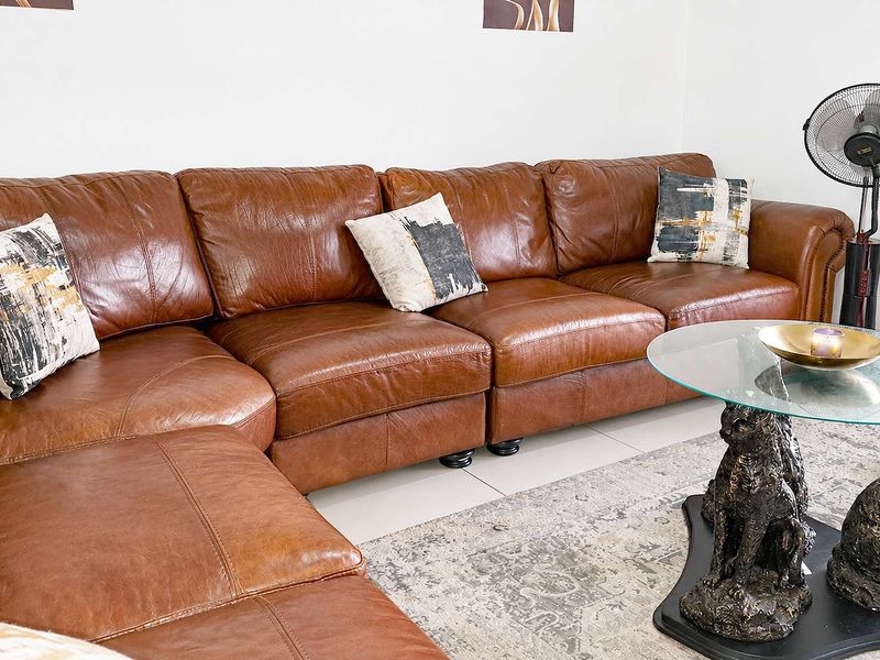 A comfortable living room area featuring neutral tiled flooring and clean wall finishes.