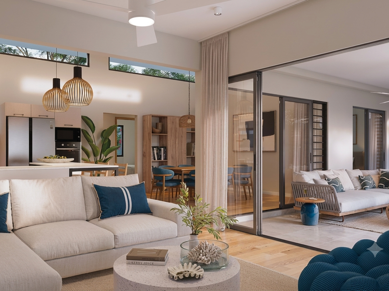 Spacious open-plan living area featuring a modern kitchen, seamless indoor-outdoor flow through large sliding doors, and high-quality finishes throughout.