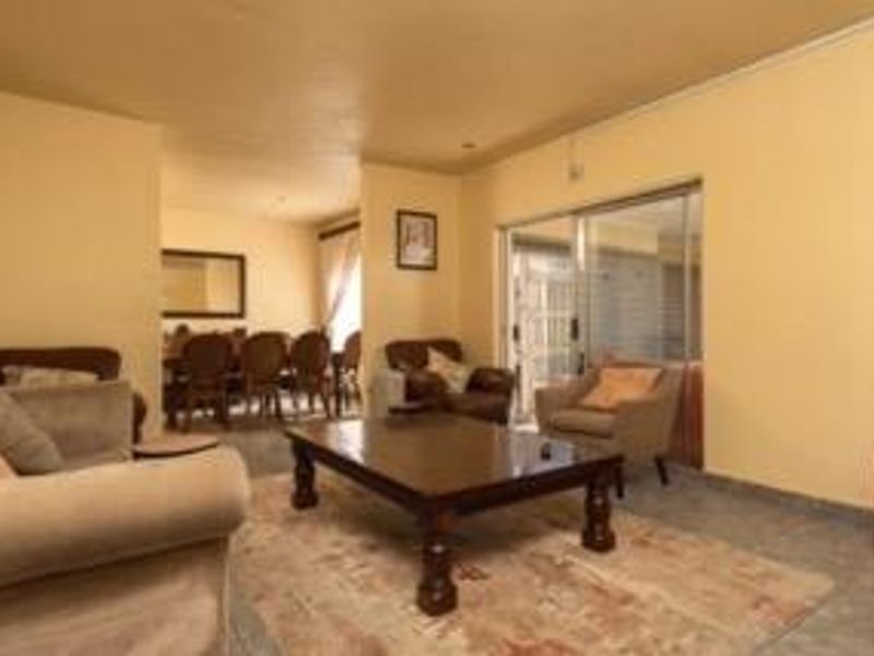 Open plan living and dining area featuring tiled flooring and a large sliding glass door providing access to the exterior.