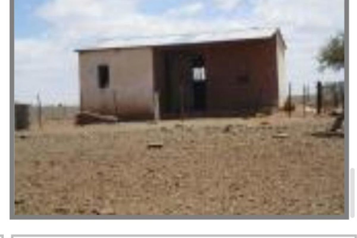 A basic detached worker dwelling on the farm property, featuring a simple structure with a metal roof.