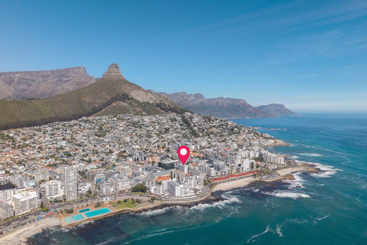 Aerial view of the coastal apartment location in Sea Point, Cape Town, showcasing proximity to the ocean and Table Mountain.