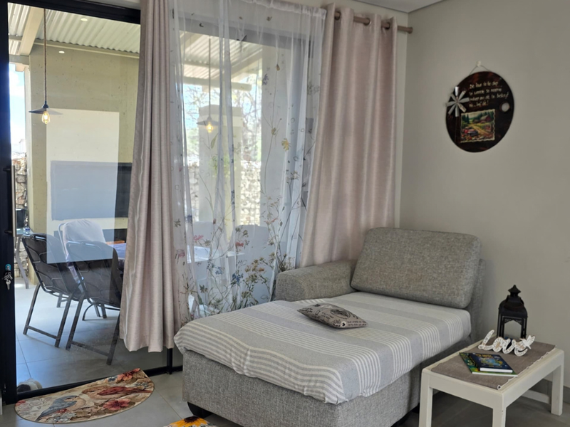 A bright living area featuring large sliding glass doors that provide seamless access to an outdoor patio space.