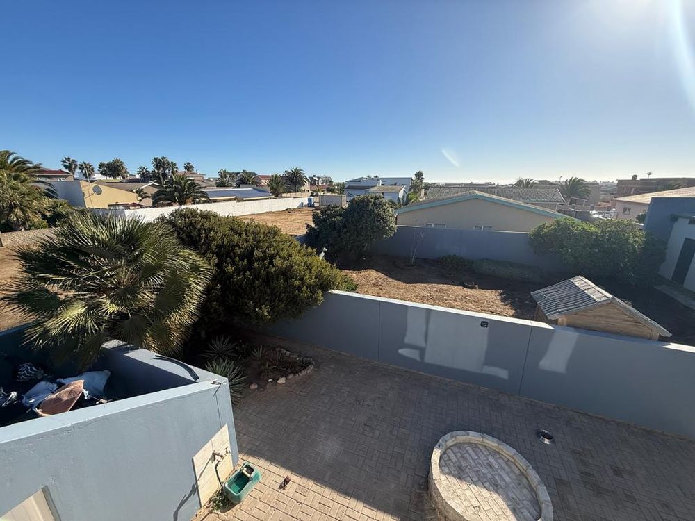 Balcony looking over the backyard. Open area for more rooms to be built. Boma for outdoor BBQ