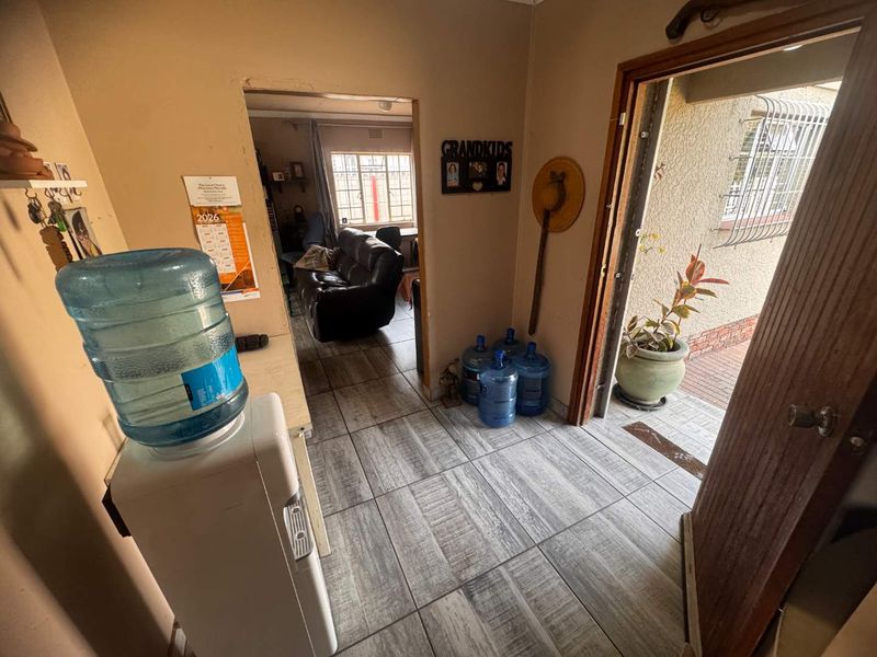 An entry area featuring tiled flooring and direct access to the exterior, providing a functional transition space into the home.