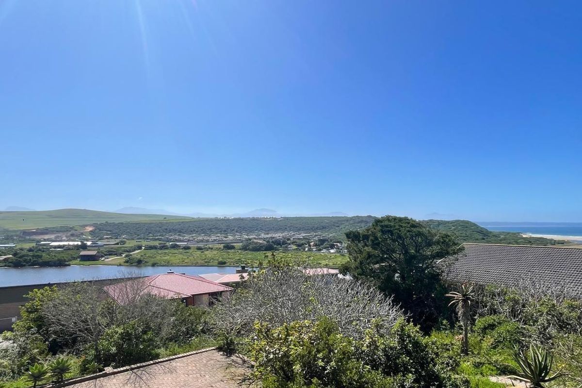 A scenic elevated view overlooking the estuary, surrounding greenery, and distant coastline, showcasing the natural landscape and peaceful setting of the property.