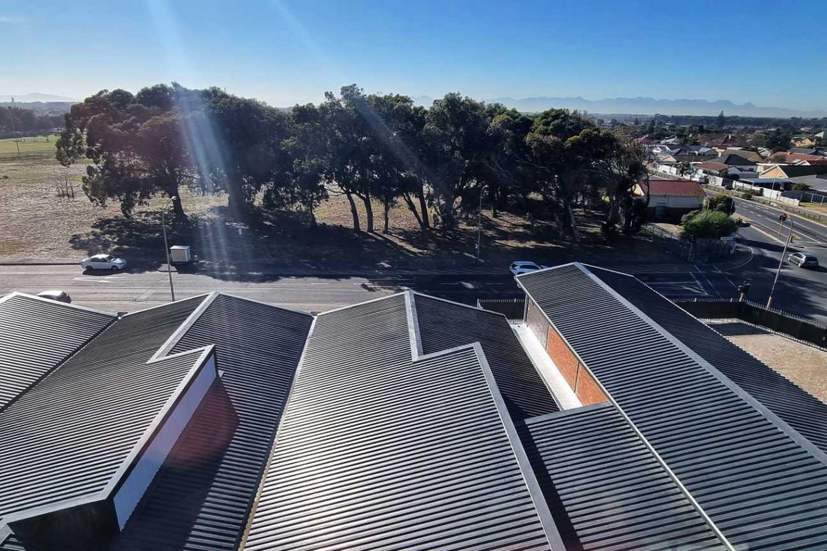 Aerial view of the industrial property showing the corrugated metal roof structure and surrounding street access.
