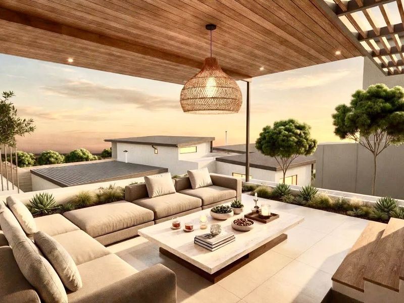 A modern, covered outdoor patio featuring a timber-clad ceiling, recessed lighting, and built-in planter boxes, offering an elevated view of the surrounding neighborhood.