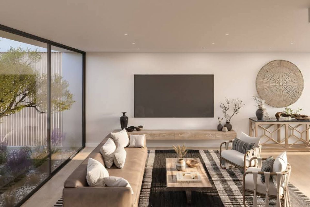 Modern open-plan living area featuring floor-to-ceiling glass doors overlooking a private courtyard, recessed lighting, and a sleek floating media console.