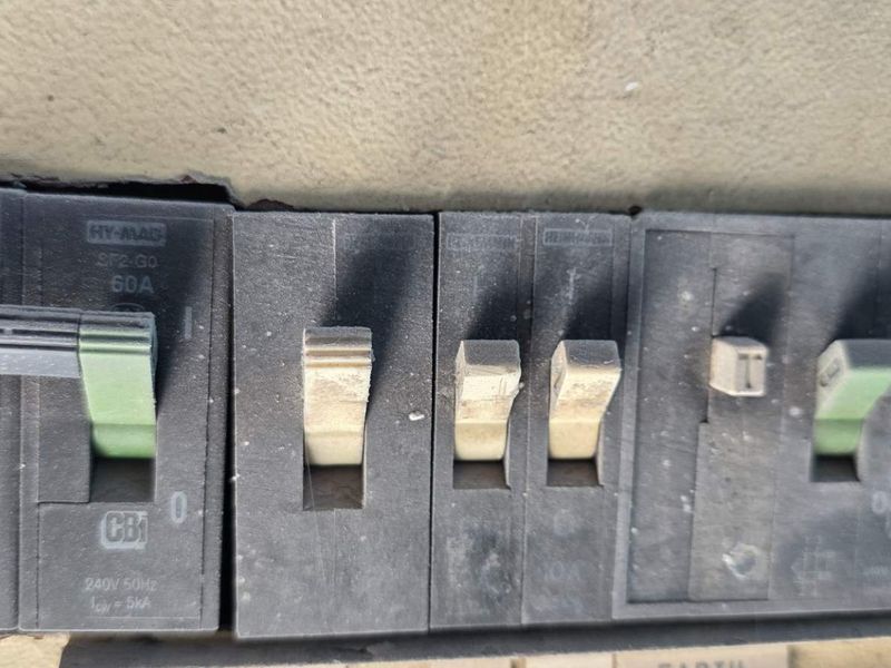 Close-up view of an industrial electrical distribution board featuring multiple circuit breakers.