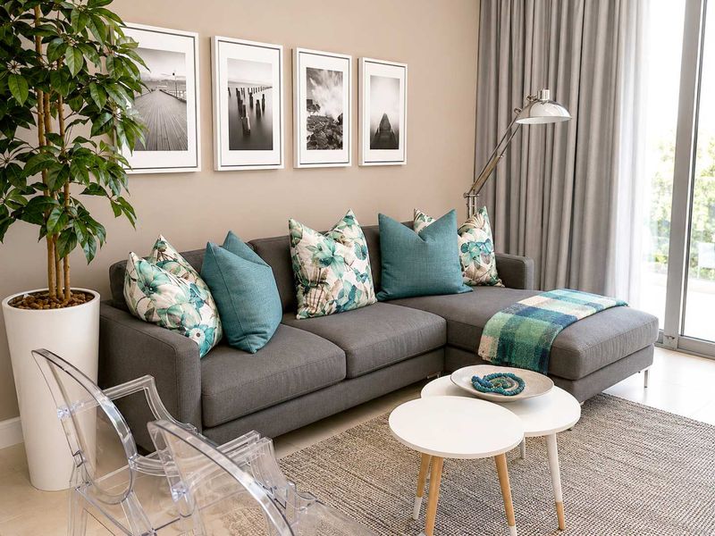 A bright and modern living room featuring neutral walls, tiled flooring, and large sliding glass doors that provide ample natural light.