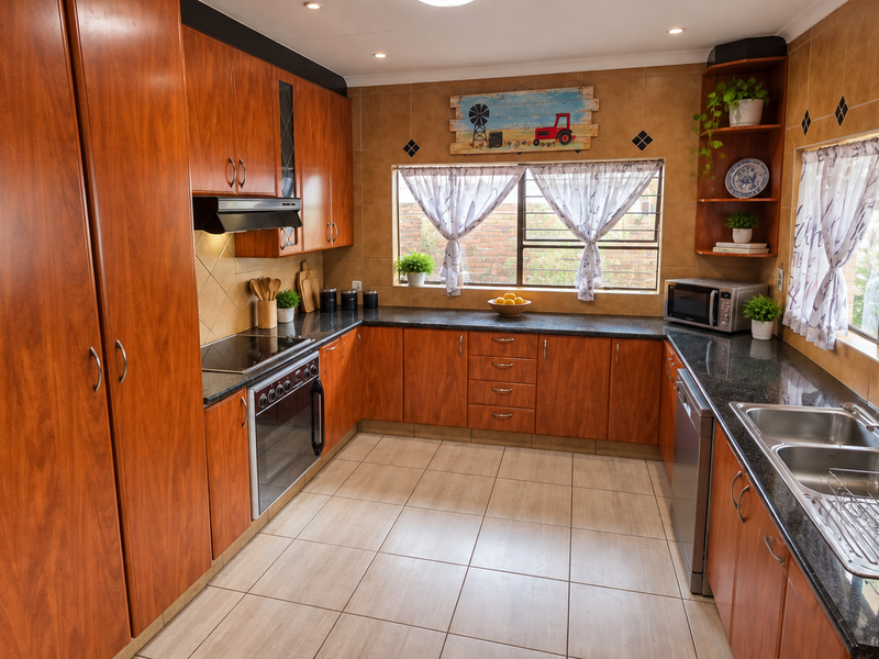 A functional kitchen featuring warm-toned wooden cabinetry, granite countertops, a built-in oven with hob, and a double basin sink with tiled finishes.