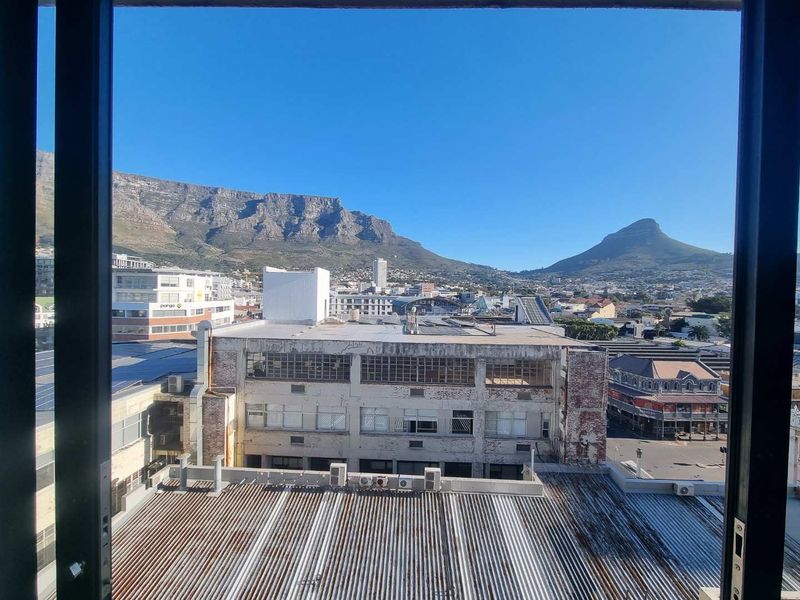 An elevated urban view looking out over the city towards Table Mountain and Lion's Head.
