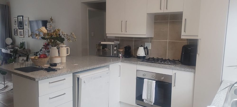 















































Kitchen with white cabinets, granite counters and dishwasher 
