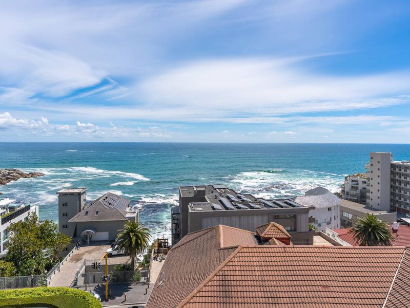 Elevated coastal view overlooking the ocean and surrounding residential apartment buildings.
