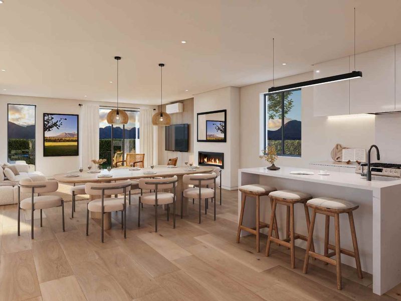 Modern open-plan living area featuring a sleek kitchen with island, dining space, and a built-in fireplace, finished with high-quality materials and neutral tones.