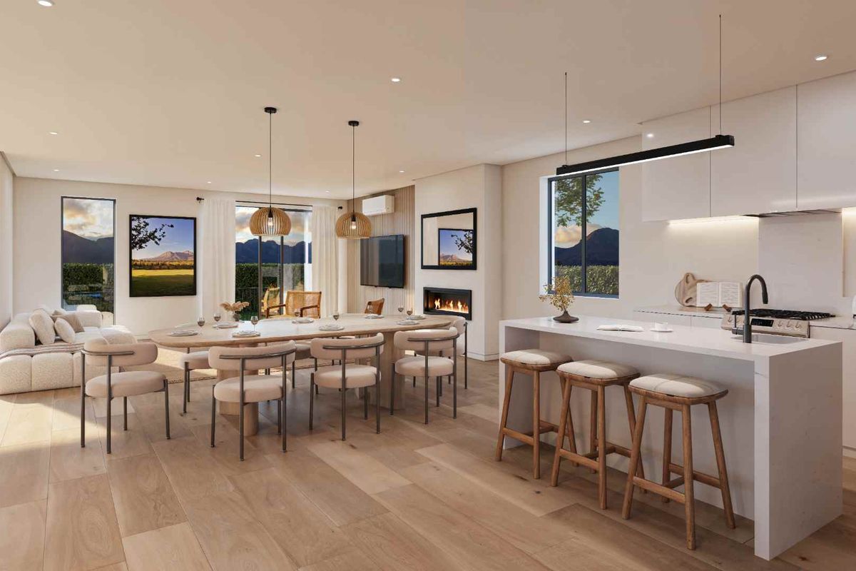 Modern open-plan living area featuring a sleek kitchen with island, dining space, and a built-in fireplace, finished with high-quality materials and neutral tones.