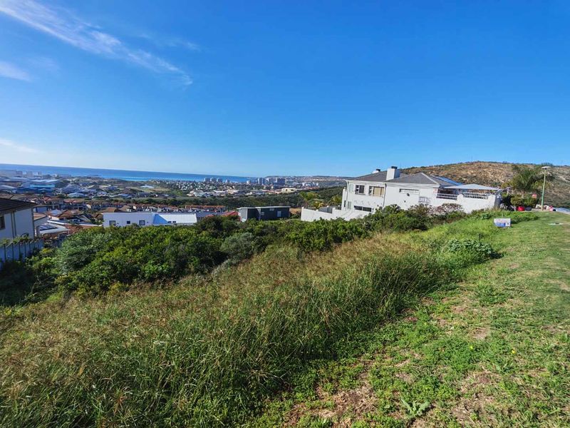 Elevated view overlooking the coastal landscape and surrounding residential neighborhood from the vacant land plot.