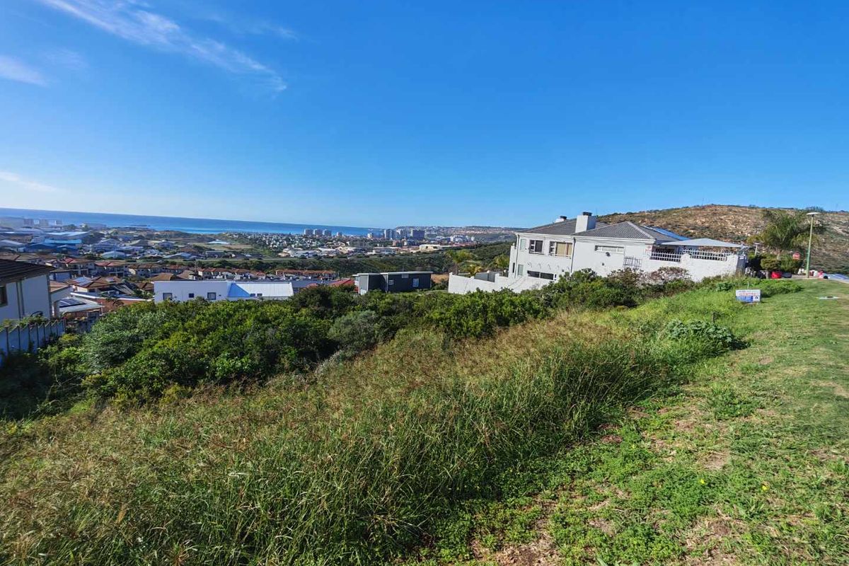 Elevated view overlooking the coastal landscape and surrounding residential neighborhood from the vacant land plot.