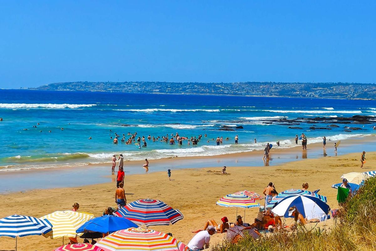 A scenic coastal view overlooking a sandy beach and the ocean, highlighting the property's proximity to local recreational amenities.