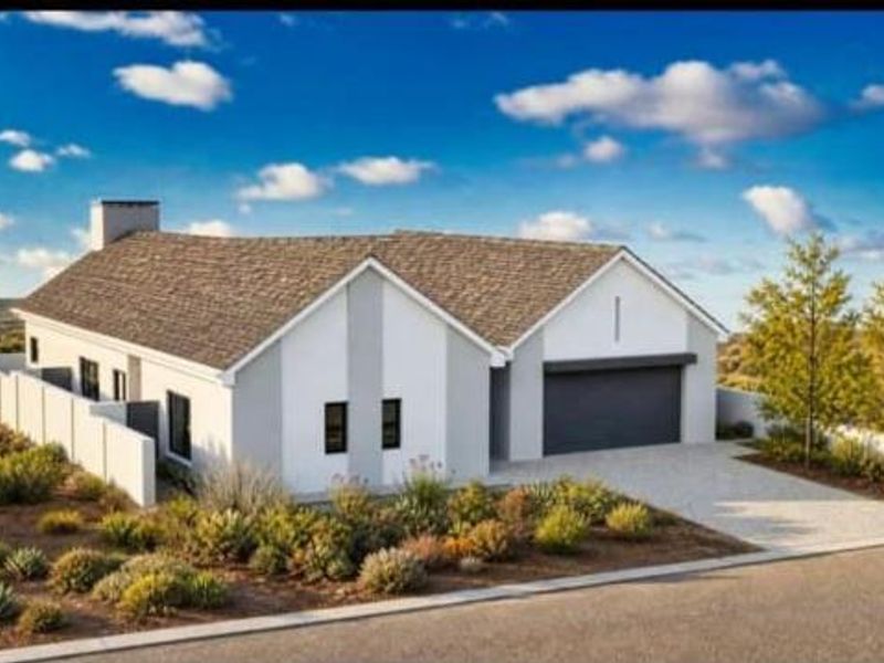 A modern single-story residential home featuring a clean white facade, pitched roof, and an integrated double garage with a paved driveway.